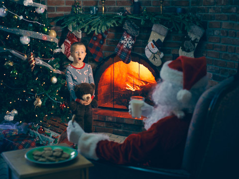 christmas photo of boy catching santa